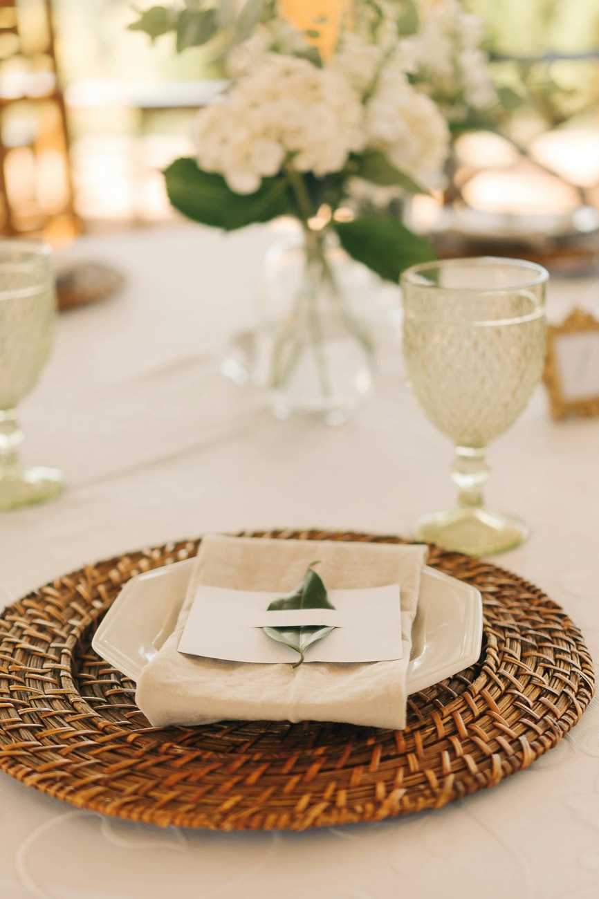 Hydrangea from the hedge in pressed glass, a rattan charger and a leaf place card